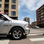 Health care worker blocks a protester's vehicle