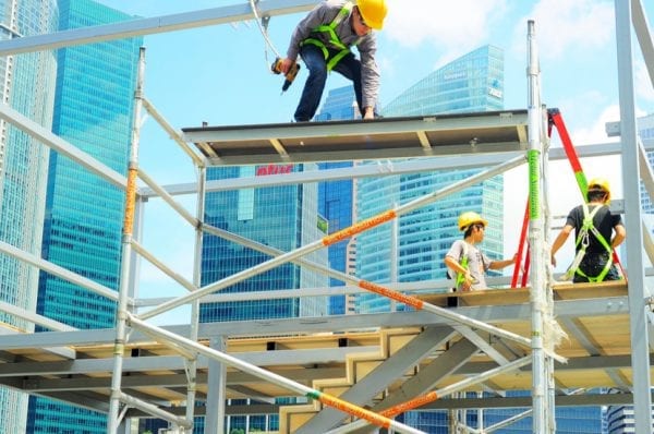 Workers at construction site in front of Singapore downtown