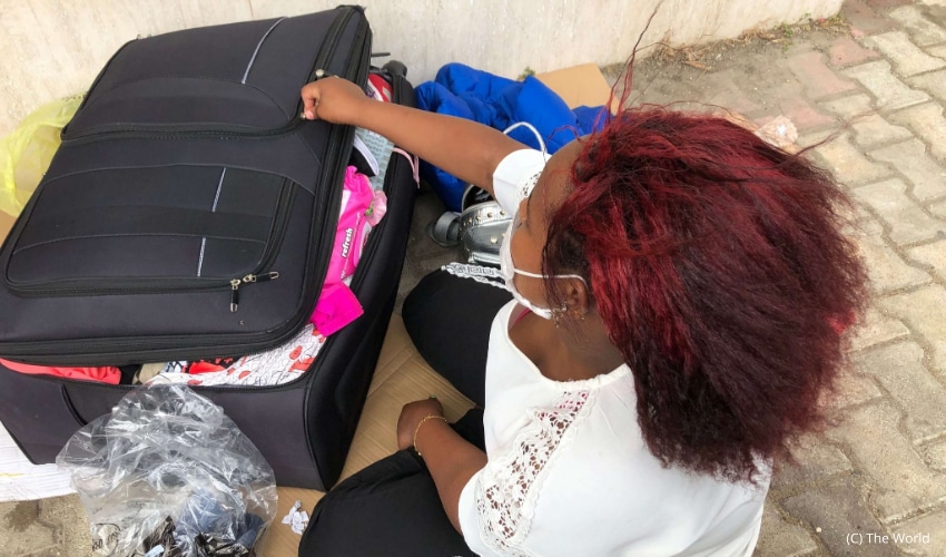 An Ethiopian woman looks through her bags outside the Ethiopian Embassy in Lebanon