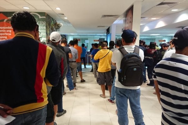 People are waiting in line to remit money via a money transfer service
