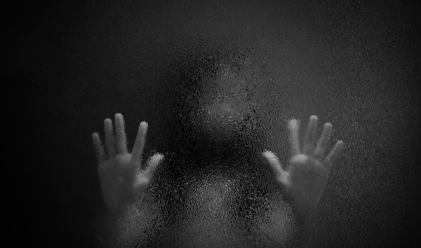 Horror scary shadow of girl behind glass in black and white