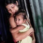 Migrant women was carrying her children