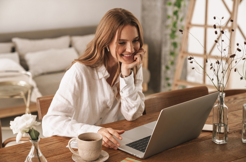 happy cheerful business woman sworks in home using laptop computer