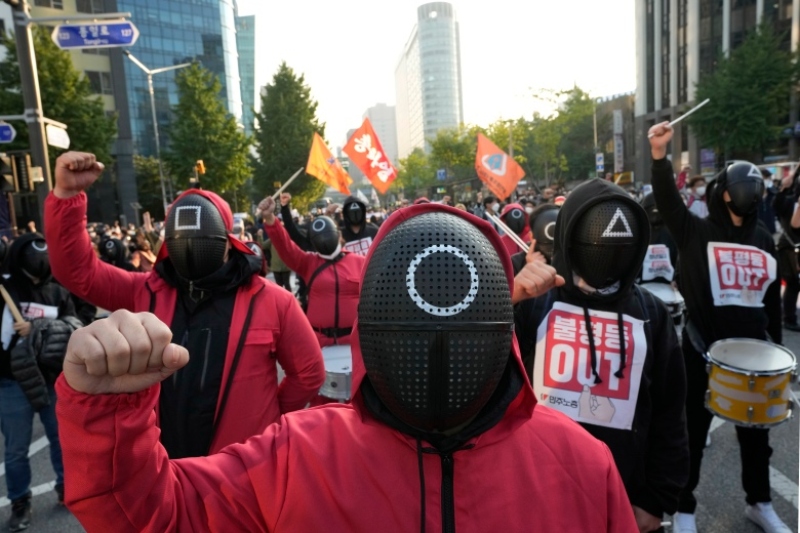 south korean workers wear 'squid game' costumes to protest government