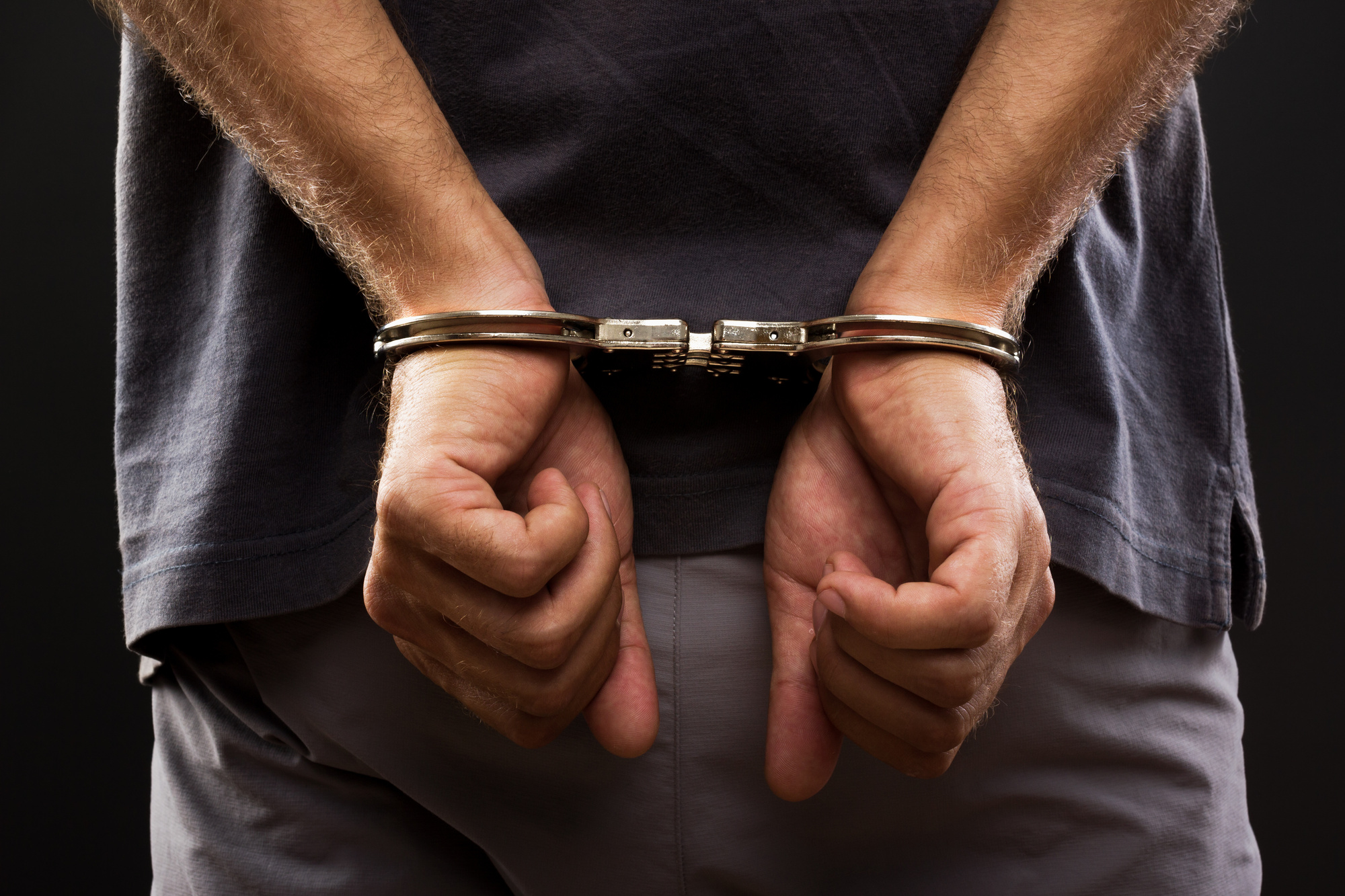 close up. arrested man handcuffed