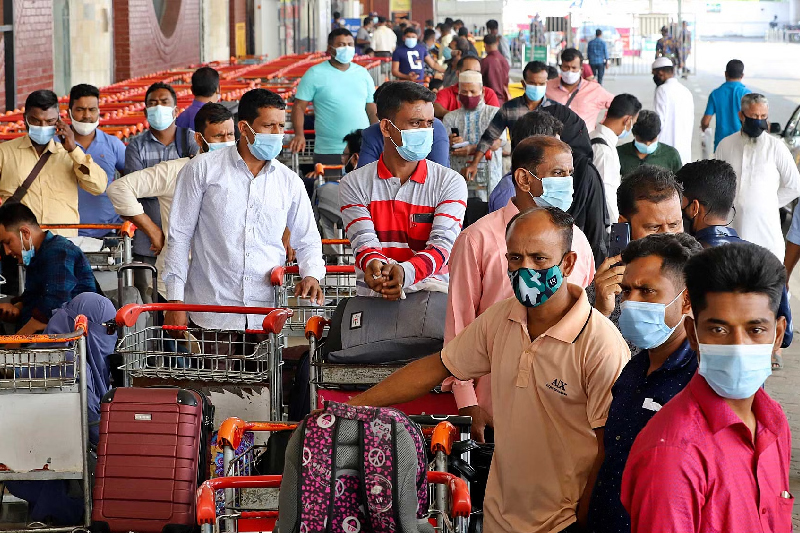 At Dhaka's bustling international airport, in the midst of the endearing scenes of families uniting, a particular gathering of travelers stands out in stark contrast.